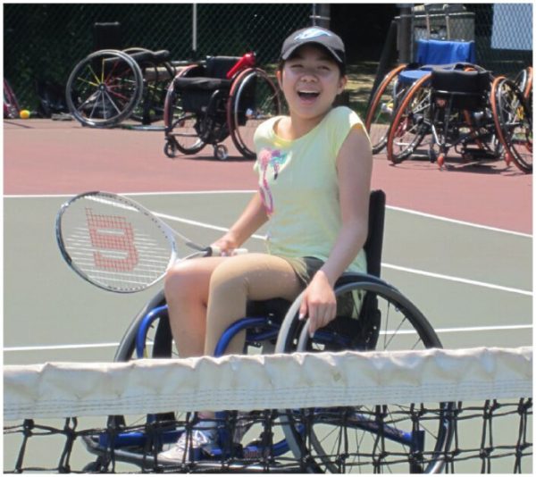 Young girl enjoying wheelchair tennis